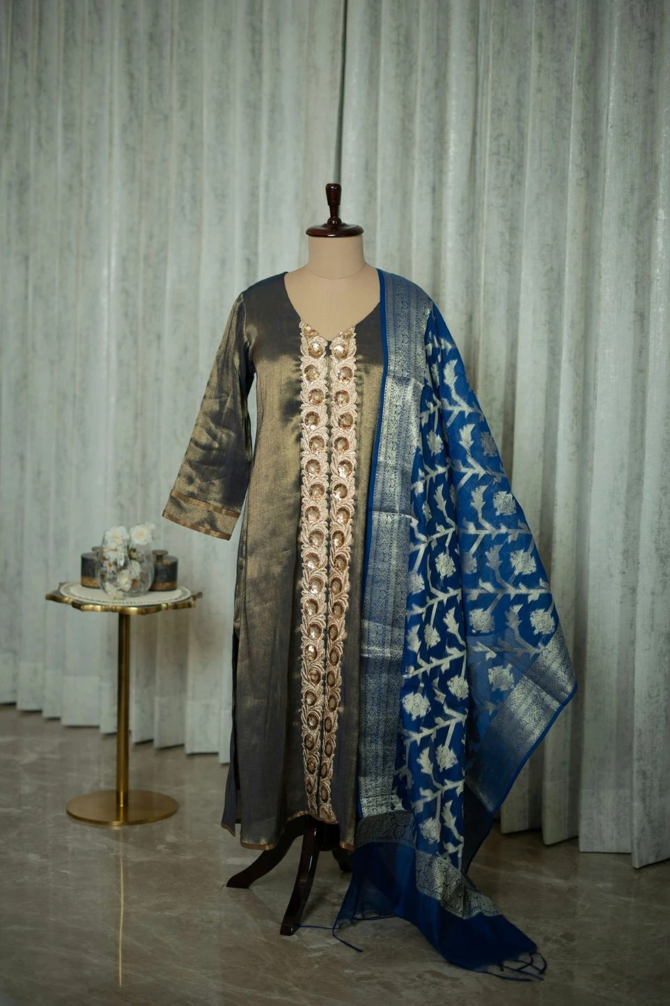 A mannequin dressed in a blue and grey outfit